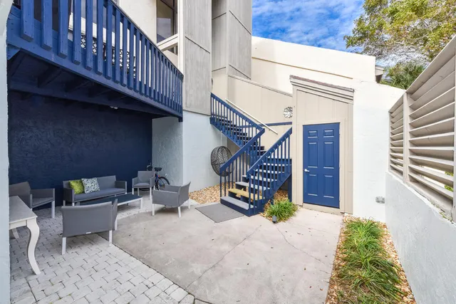 a view of a patio with table and chairs with wooden fence and plants