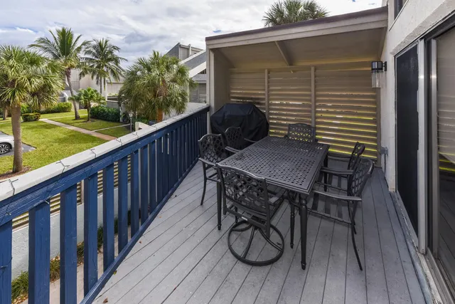 a view of balcony with wooden floor and outdoor seating