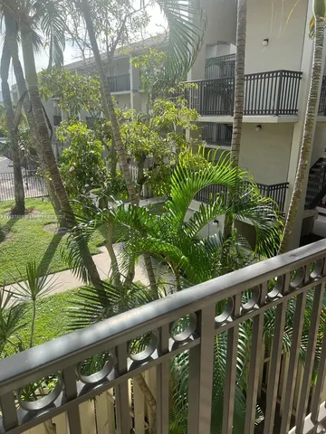 a view of an empty room and kitchen space