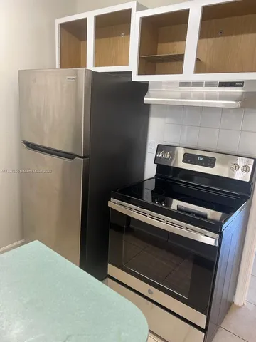 a kitchen with granite countertop a sink and a stove
