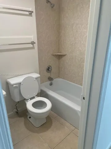 a utility room with a sink a toilet and a mirror