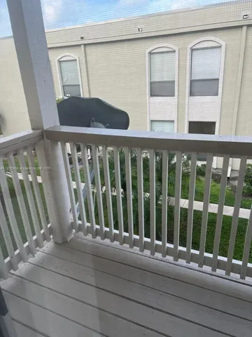 a view of a two chairs in the balcony