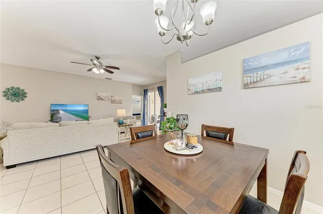 a view of a dining room with furniture and chandelier