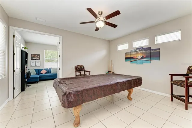 a large kitchen with kitchen island a stove a sink a dining table and chairs