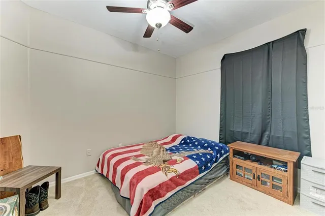 a bedroom with a bed and a chair