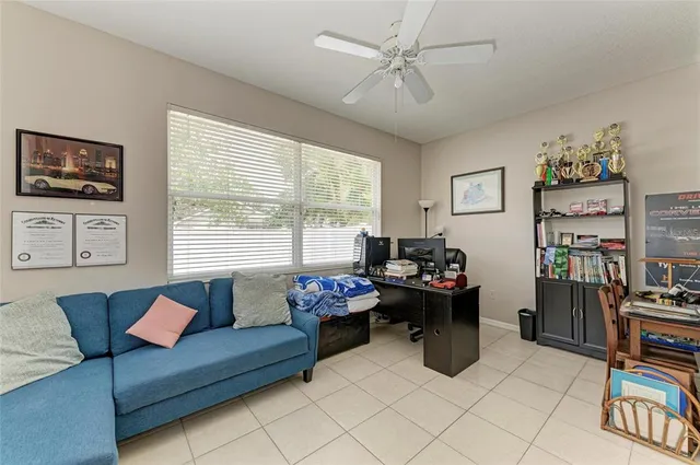 a living room with furniture a air conditioner and a large window