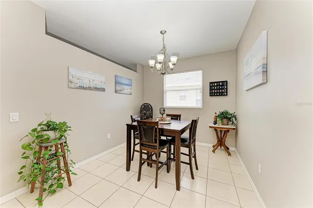 a view of a dining room with furniture and chandelier