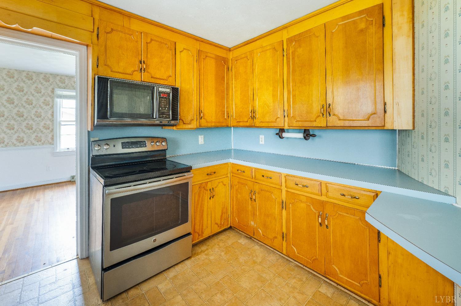 733 Oakville Road Appomattox, VA 24522 - Photo 21 of 52 a kitchen with stainless steel appliances granite countertop a stove a sink and a microwave