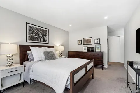 a bed room with a bed and a night stand