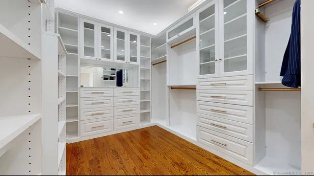 a view of walk in closet with empty racks