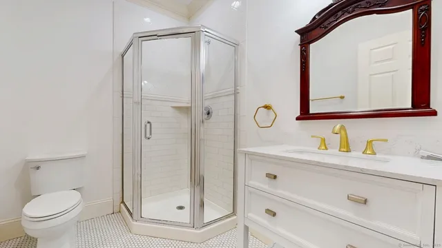 a bathroom with a granite countertop sink a toilet and a mirror