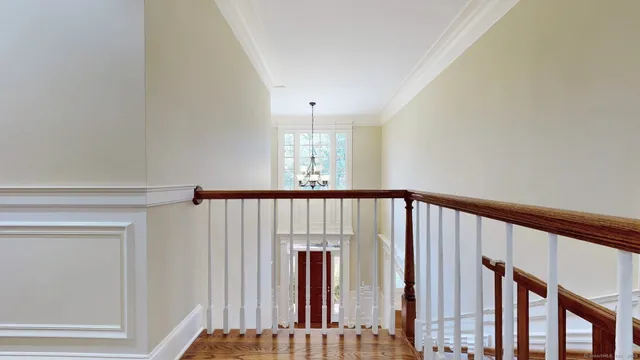 a view of staircase with railing and a window