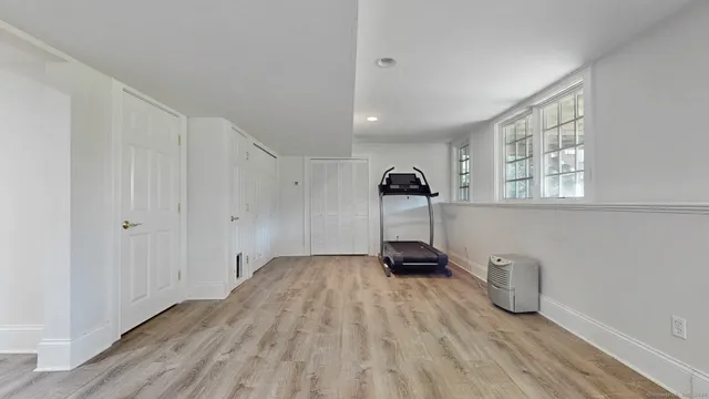 a view of a room with wooden floor and windows