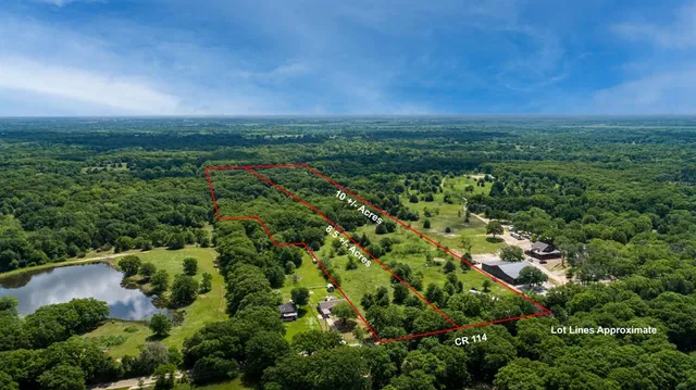 an aerial view of a city with lots of residential buildings and mountain view in back