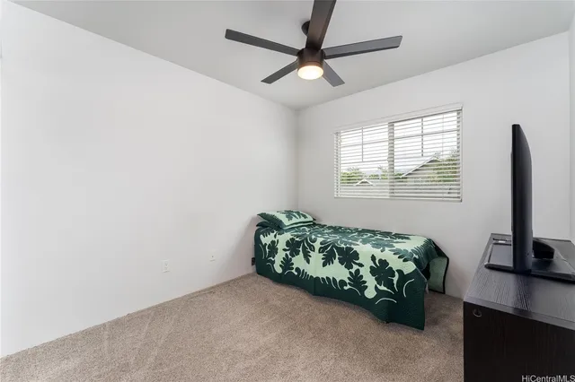 a living room with a bed furniture and a window