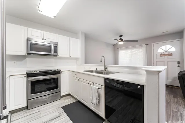 a kitchen with stainless steel appliances granite countertop a stove top oven and sink