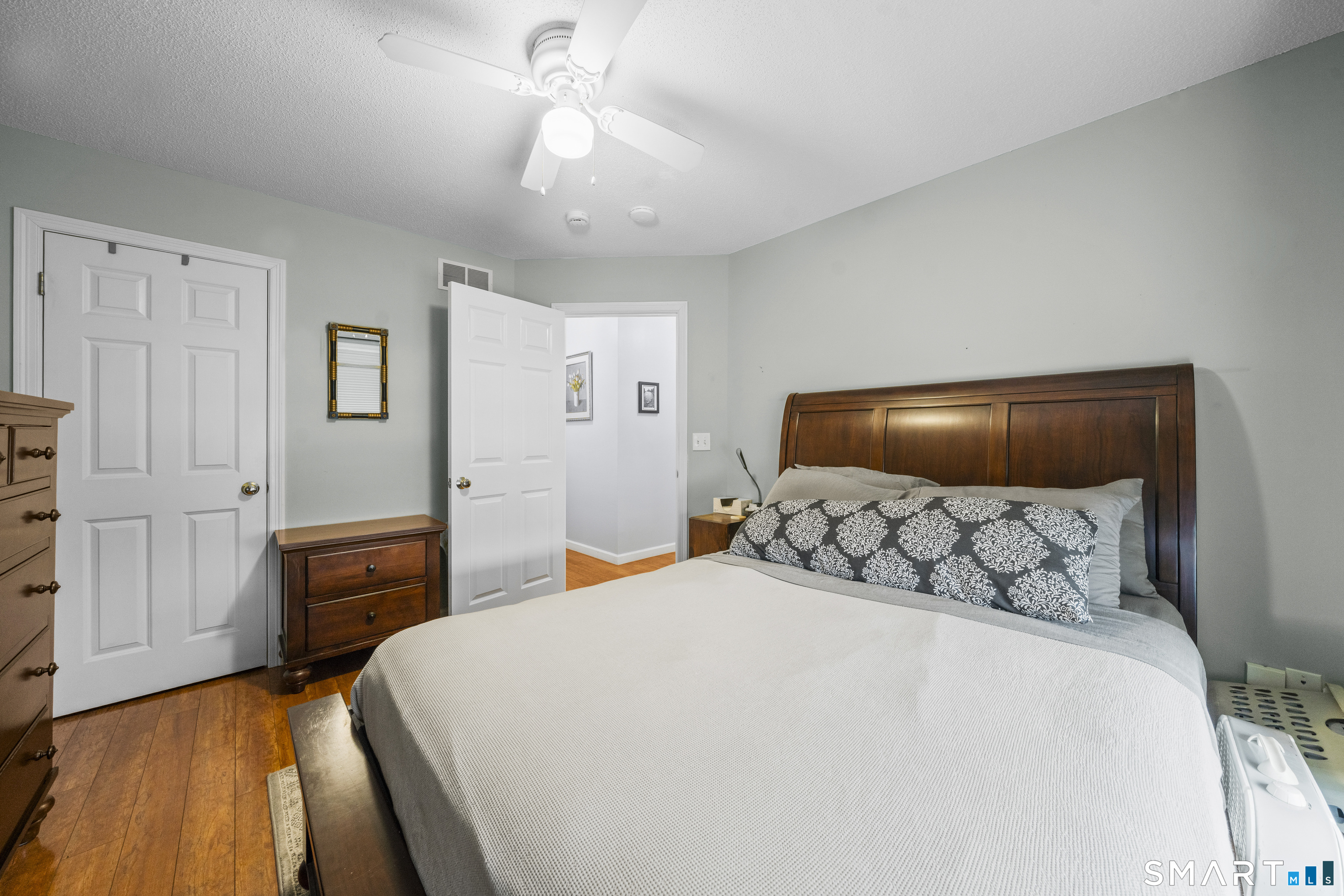 7 Heather Lane, Unit 7 Suffield, CT 06078 - Photo 13 of 34 a bedroom with a bed and a chandelier