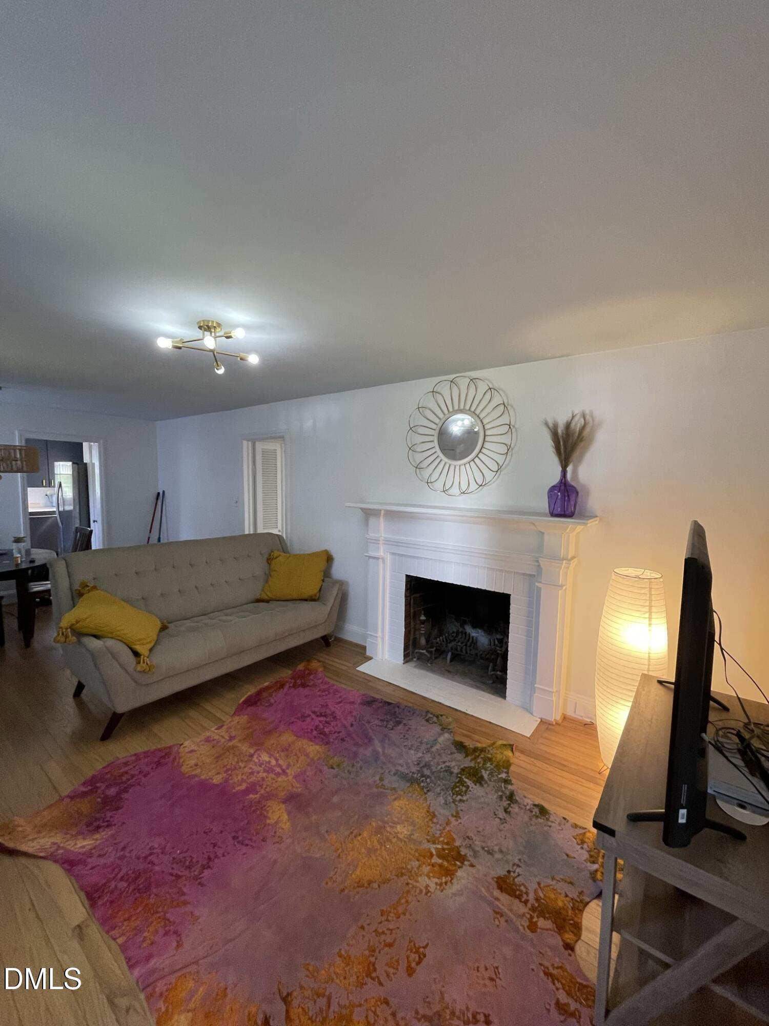 1009 Canterbury Road Raleigh, NC 27607 - Photo 28 of 31 a bedroom with a bed and a fireplace
