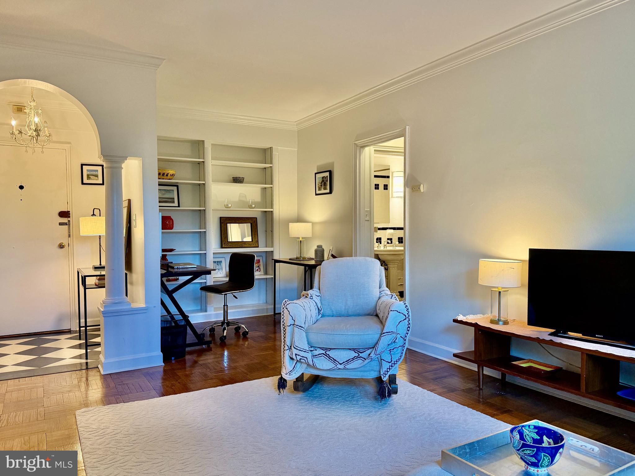 2500 Q Street Northwest, Unit 307 Washington, DC 20007 - Photo 6 of 17 a living room with furniture and a flat screen tv