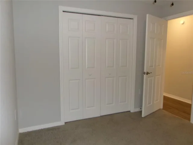an empty room with closet area