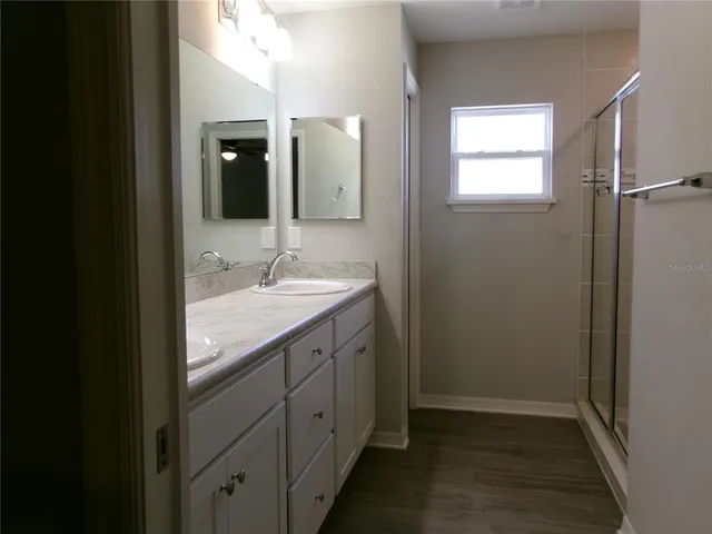 a bathroom with a granite countertop sink mirror and double