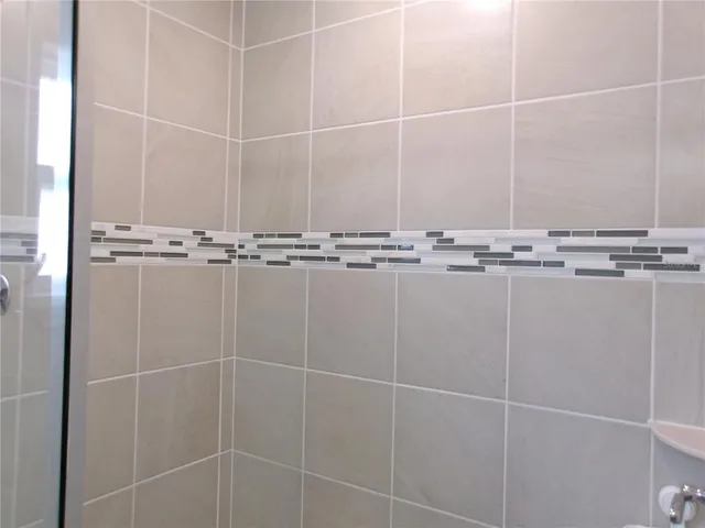 a bathroom with a shower and a sink