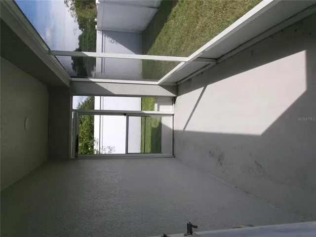 a view of a room with a floor to ceiling window