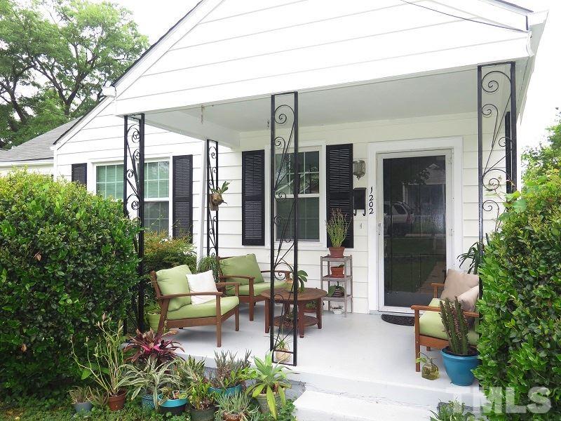 1202 Clifton Street Raleigh, NC 27604 - Photo 2 of 14 a backyard of a house with outdoor seating and green space