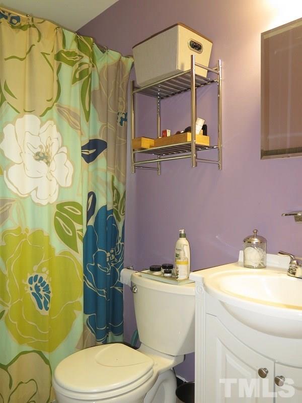1202 Clifton Street Raleigh, NC 27604 - Photo 11 of 14 a bathroom with a toilet sink and mirror