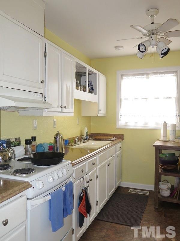 1202 Clifton Street Raleigh, NC 27604 - Photo 6 of 14 a kitchen with a sink and cabinets