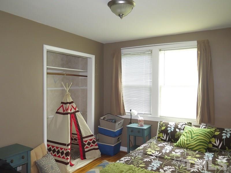 1202 Clifton Street Raleigh, NC 27604 - Photo 9 of 14 a bedroom with furniture and a window