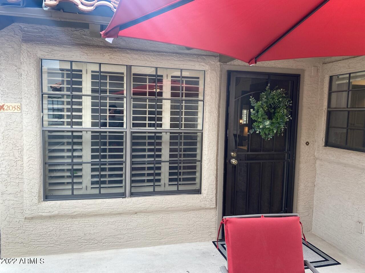 10017 East Mountain View Road, Unit 2058 Scottsdale, AZ 85258 - Photo 11 of 37 a front view of a house with a yard