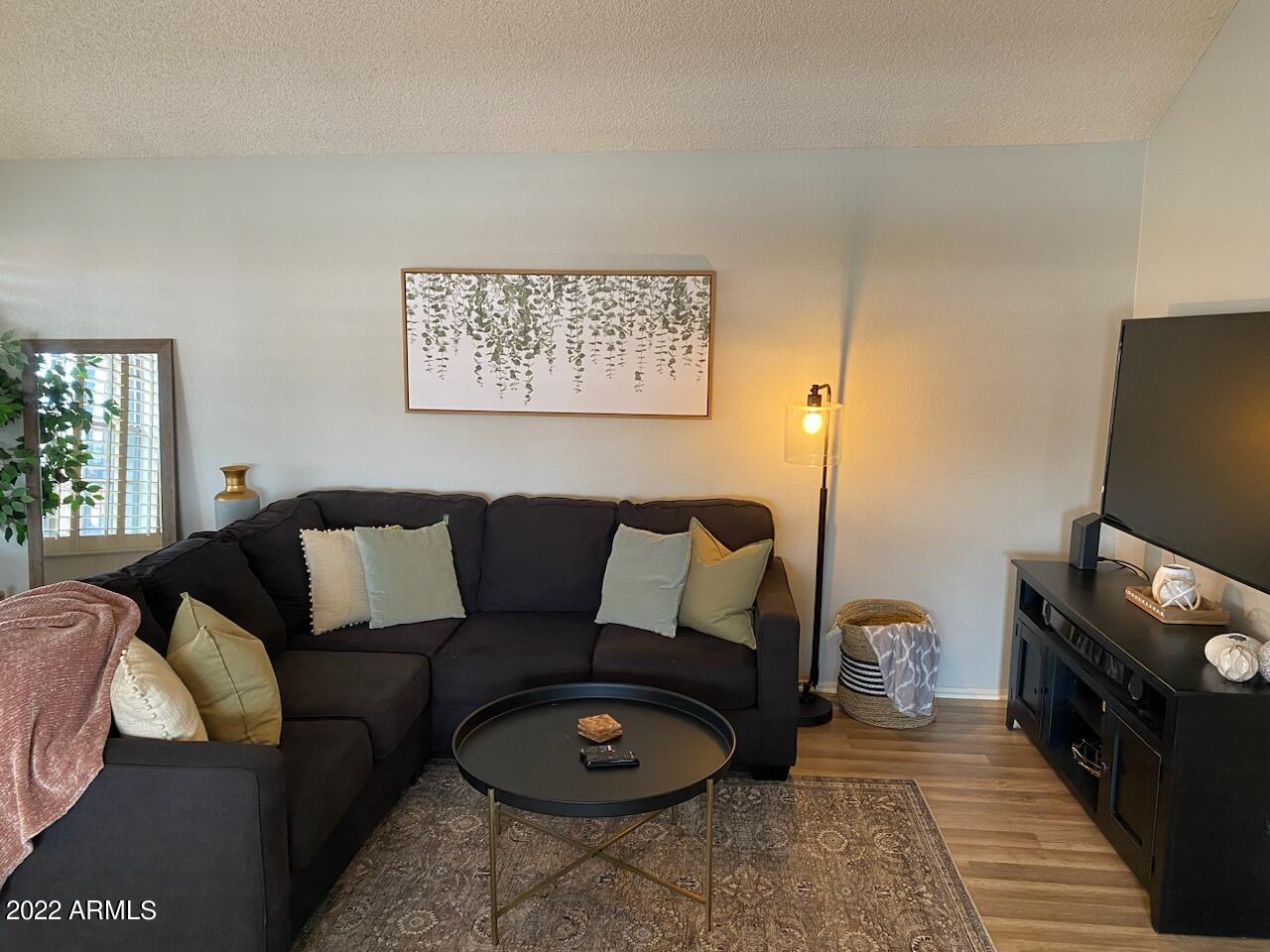 10017 East Mountain View Road, Unit 2058 Scottsdale, AZ 85258 - Photo 15 of 37 a living room with furniture and a flat screen tv