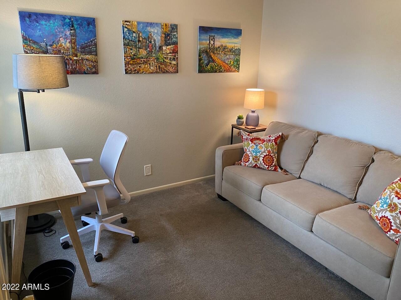 10017 East Mountain View Road, Unit 2058 Scottsdale, AZ 85258 - Photo 17 of 37 a living room with furniture and a chair