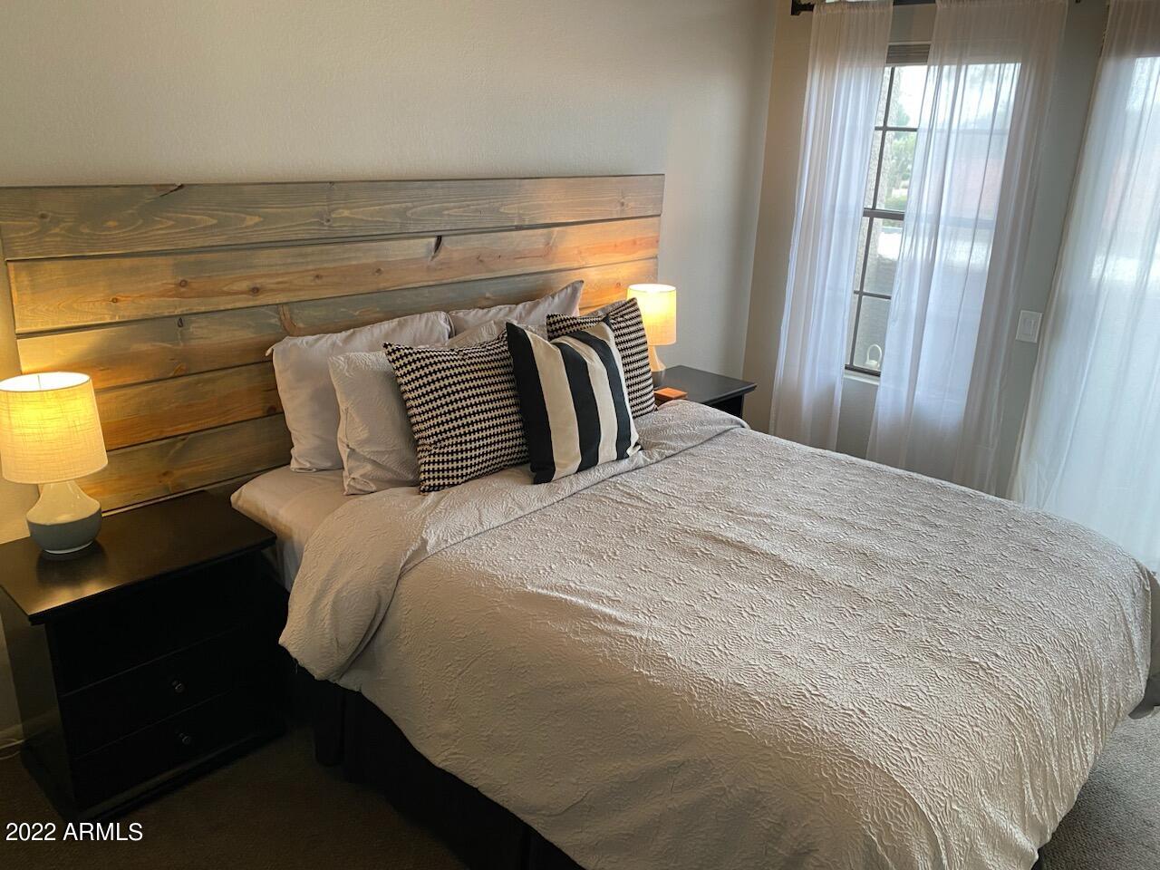 10017 East Mountain View Road, Unit 2058 Scottsdale, AZ 85258 - Photo 18 of 37 a bedroom with a bed and wooden floor