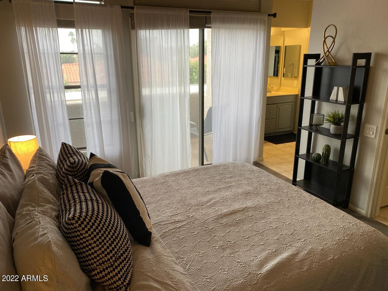 10017 East Mountain View Road, Unit 2058 Scottsdale, AZ 85258 - Photo 19 of 37 a bedroom with a bed and wooden floor