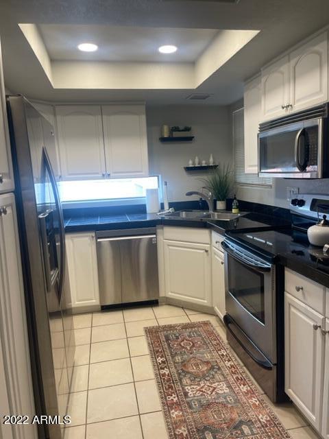 10017 East Mountain View Road, Unit 2058 Scottsdale, AZ 85258 - Photo 21 of 37 a kitchen with stainless steel appliances granite countertop a stove a sink and a microwave