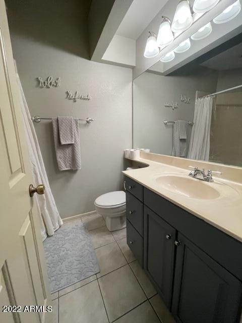 10017 East Mountain View Road, Unit 2058 Scottsdale, AZ 85258 - Photo 27 of 37 a bathroom with a sink a toilet a mirror and vanity