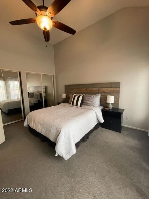 10017 East Mountain View Road, Unit 2058 Scottsdale, AZ 85258 - Photo 30 of 37 a bedroom with a bed and a chandelier