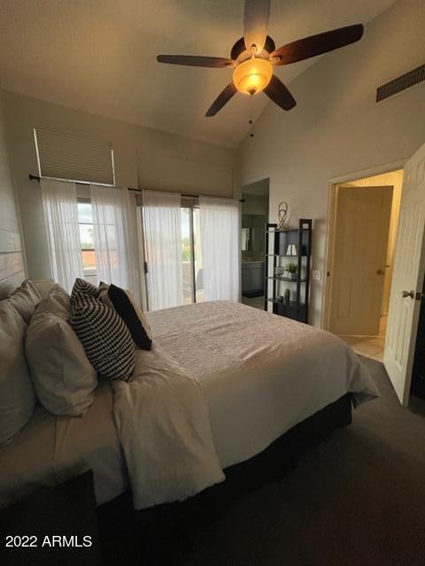 10017 East Mountain View Road, Unit 2058 Scottsdale, AZ 85258 - Photo 31 of 37 a bedroom with a bed and a chandelier