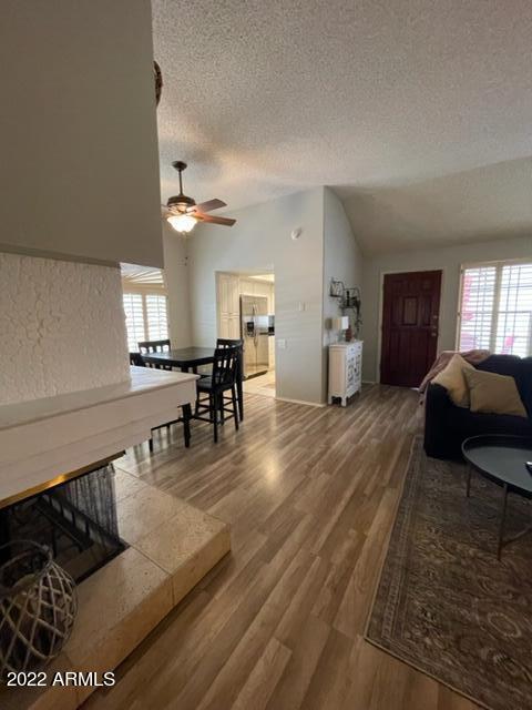 10017 East Mountain View Road, Unit 2058 Scottsdale, AZ 85258 - Photo 34 of 37 a living room with furniture and a wooden floor