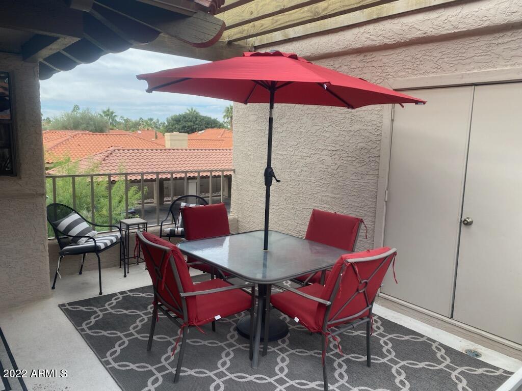 10017 East Mountain View Road, Unit 2058 Scottsdale, AZ 85258 - Photo 9 of 37 a dining room with furniture and a floor to ceiling window