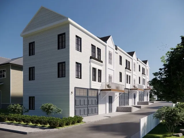 a front view of a building with a yard and plants