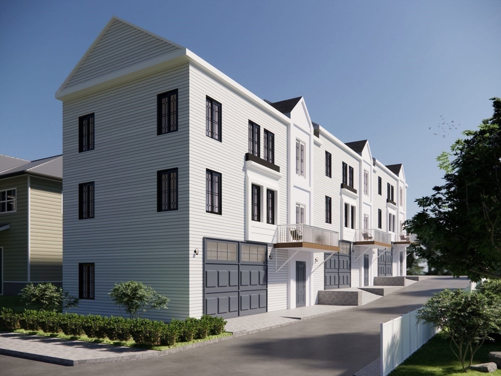 26 Maxwell Street Worcester, MA 01607 - Photo 3 of 6 a front view of a building with a yard and plants