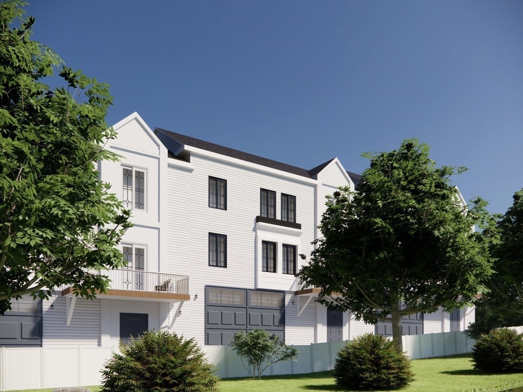 26 Maxwell Street Worcester, MA 01607 - Photo 6 of 6 a view of a white house next to a yard with potted plants and trees