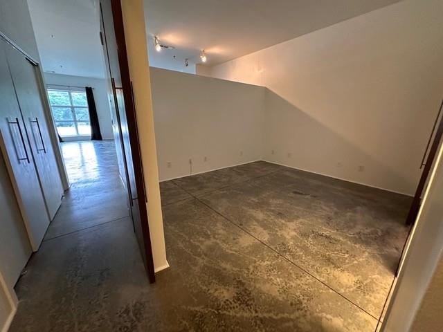 560 Dutch Valley Road Northeast, Unit 2413 Atlanta, GA 30324 - Photo 3 of 11 wooden floor in an empty room with a mirror