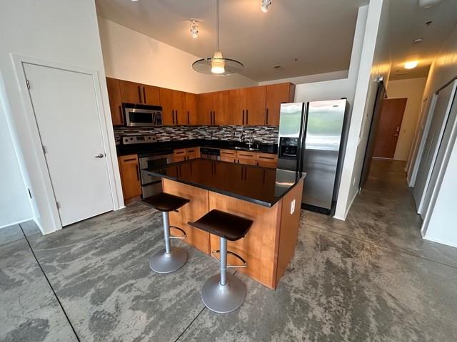 560 Dutch Valley Road Northeast, Unit 2413 Atlanta, GA 30324 - Photo 7 of 11 a kitchen with stainless steel appliances kitchen island granite countertop a table chairs sink and cabinets