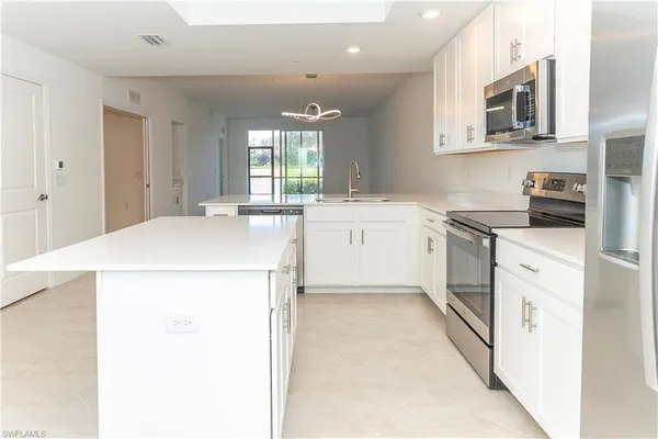 a kitchen with a sink a stove and cabinets