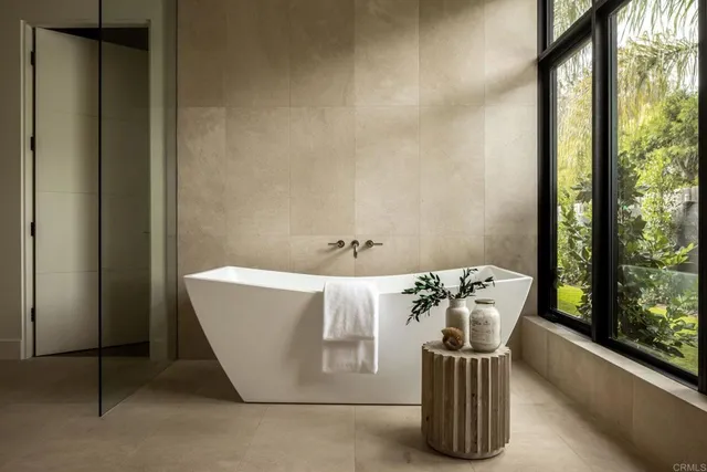 a bath tub sitting in a bathroom next to a window