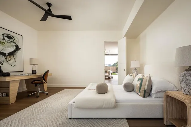 a bedroom with a bed a desk and chair